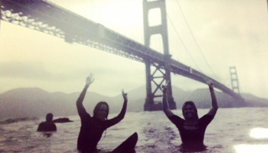 Lyndsay Noyes and Sage Erickson surf under the Golden Gate Bridge Photo: Instagram @__noyes__